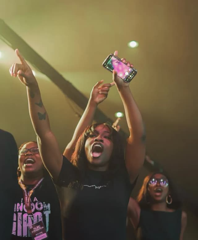 Crowd with hands and phones up at AYAC USA