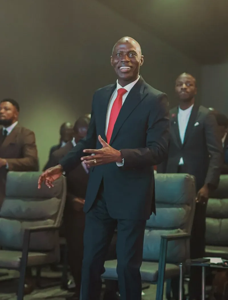 Pastor smiling in red tie at AYAC USA