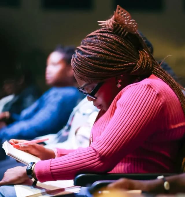 Woman reading Bible during AYAC USA service