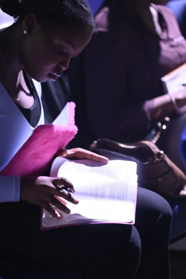 Youth reading Bible during service